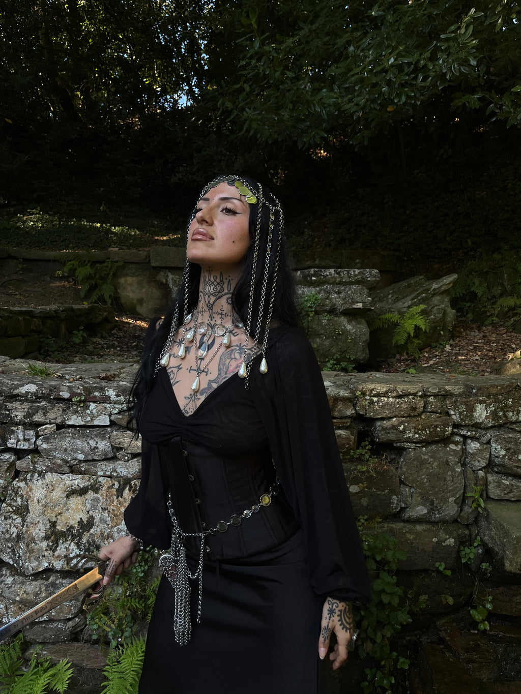 Medieval knight-inspired headpiece with cascading chains, upcycled chandelier crystals, and pearl drops.