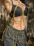Golden Serpent handmade gold-tone brass ball-chain body harness and waist belt by NiX Jewelry, displayed on a mannequin outdoors.
