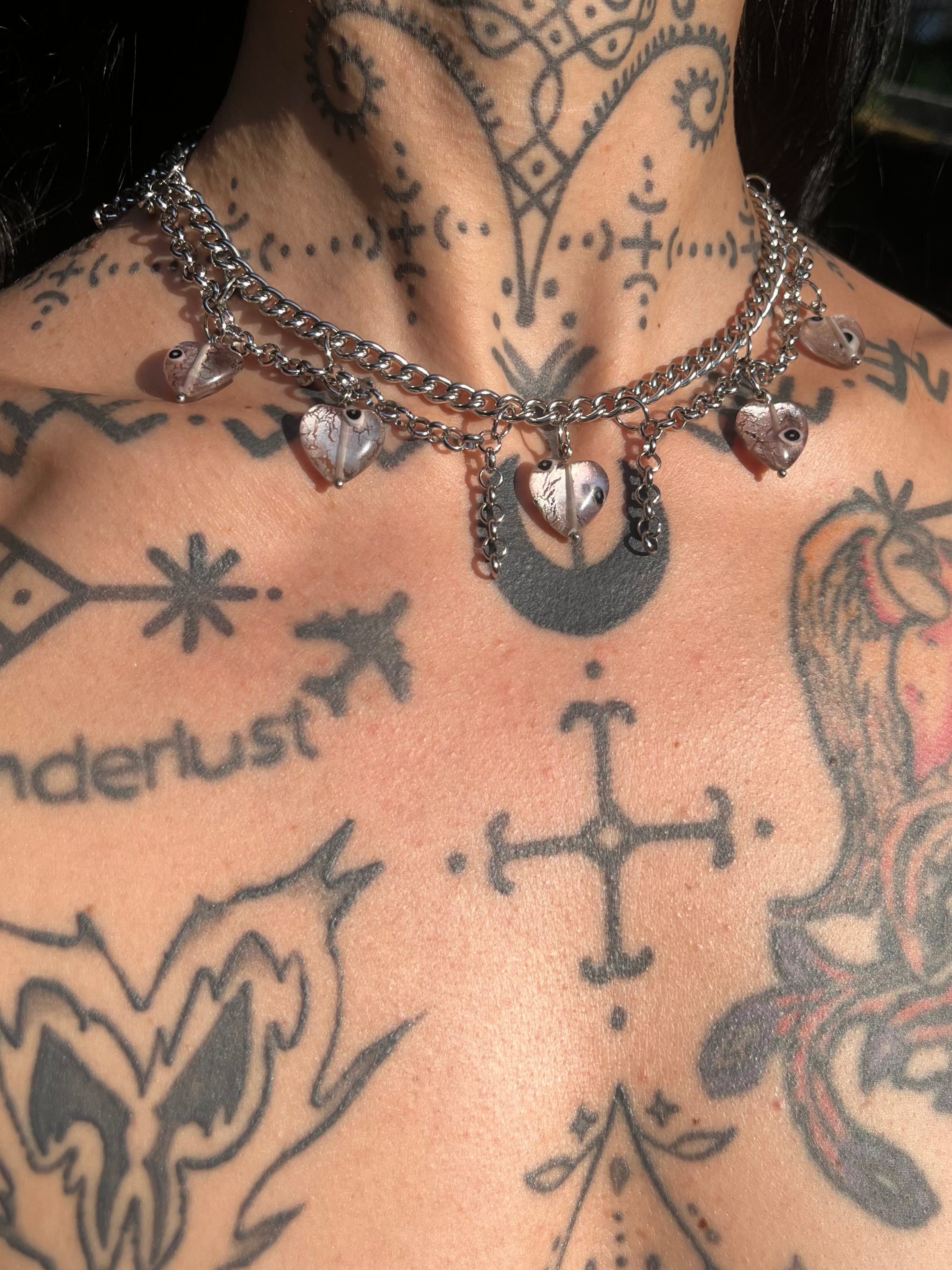 Handmade Italian glass heart necklace with evil eye beads and layered silver-tone chains
